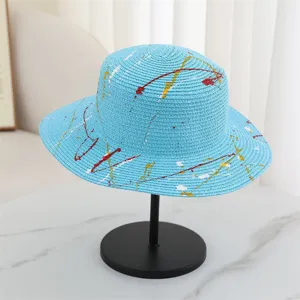 Summer blue straw hat with colorful paint splatter design, perfect for beach sun protection and travel.