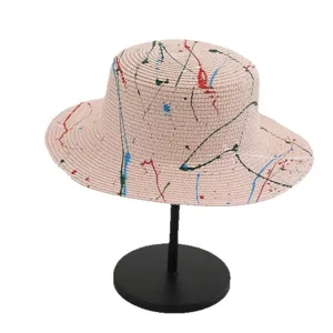 Flat top straw hat with colorful paint splatter design, ideal for summer beach sun protection.
