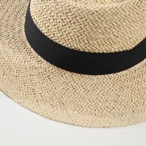 Detailed view of the women straw sun hat with black band, summer flat top beach hat.