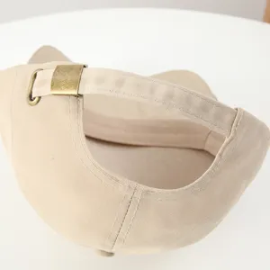 Detail view of khaki casual baseball cap with adjustable metal buckle back strap.