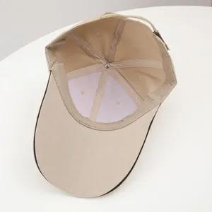Detailed view of the inner structure of a classic khaki baseball cap with adjustable strap.