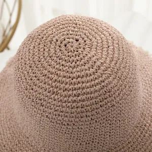 Close-up of women summer straw bucket hat crochet woven texture delicate details breathable sun hat.
