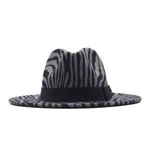 Close-up detail of the black and grey striped fedora hat with black bow ribbon accent.