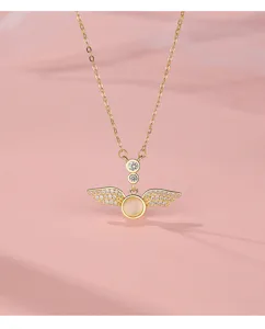 Detailed close-up view of the elegant gold angel wings necklace sparkling with zirconia stones.
