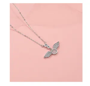 Detailed view of the sterling silver angel wings necklace featuring sparkling cubic zirconia stones.