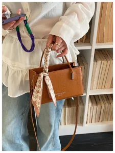 Trendy brown crocodile pattern shoulder crossbody small square bag with elegant scarf detail.