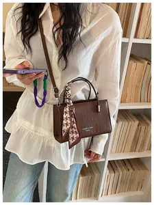 Brown crocodile pattern crossbody shoulder bag with stylish houndstooth scarf detail.