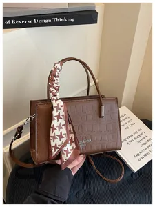 Brown crocodile pattern small shoulder crossbody bag with elegant printed scarf accessory.