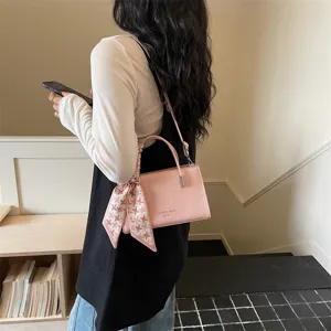 Trendy pink faux leather shoulder crossbody bag with elegant patterned scarf decoration for women