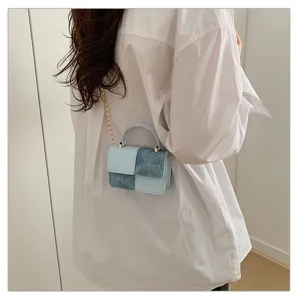 Chic mini crossbody bag featuring color-blocked denim and leather design with stylish chain.
