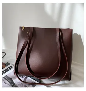 Detailed shot of dark brown minimalist shoulder tote bag, premium leather texture, elegant daily wear