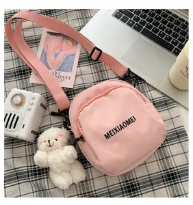 Pink canvas crossbody bag for women, cute casual shoulder bag with plush bear pendant.