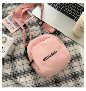 Pink canvas crossbody bag for women, cute Korean style casual shoulder bag with zipper pocket.