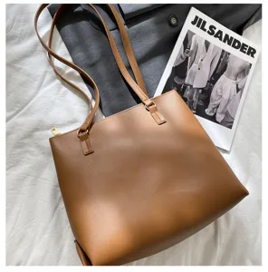 Brown leather tote bag detail, large capacity shoulder bag for women, elegant daily commute style.