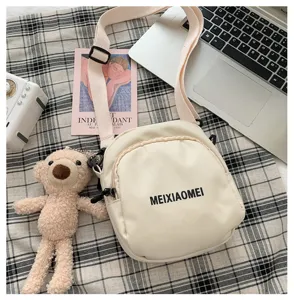 Cute canvas crossbody bag for women, Korean style casual messenger bag with bear pendant detail.