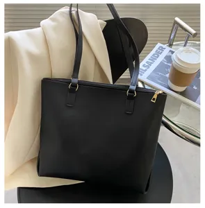 Minimalist black leather shoulder tote bag detail shot showing elegant daily commuting style