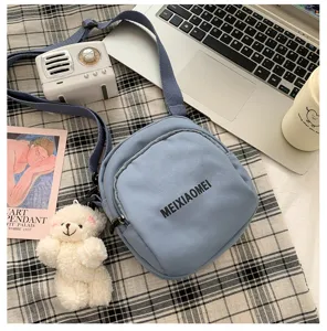 Ins style blue canvas crossbody bag for women, casual cute shoulder bag with cute bear pendant.