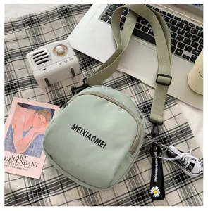 Canvas crossbody bag for women, cute Korean style green shoulder bag with letters.