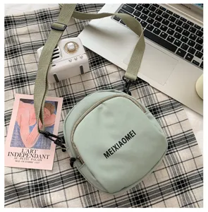 Detailed view of the light green canvas crossbody bag, casual cute student shoulder bag.
