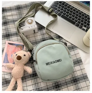 Korean style canvas crossbody bag for women, cute small shoulder bag for daily casual use.