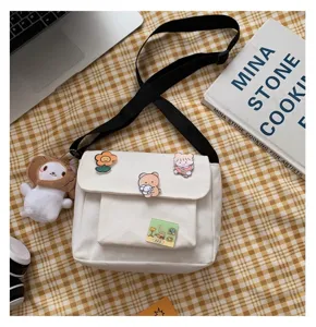Cute Japanese canvas crossbody bag for women, casual white shoulder bag with cute pins.