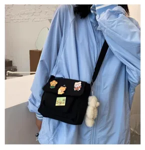Casual Harajuku canvas crossbody bag with cute pins and plush bear pendant detail.