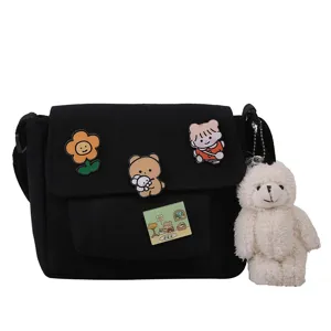 Black canvas crossbody bag for women, cute Harajuku style shoulder bag with plush bear charm.