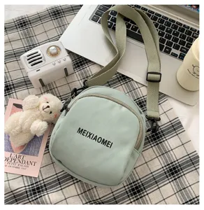 Korean style canvas crossbody bag for women, casual single shoulder bag with cute bear pendant.