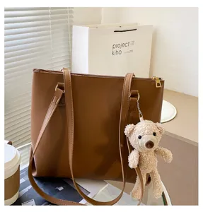 Brown large capacity women shoulder tote bag with cute bear pendant for autumn winter.