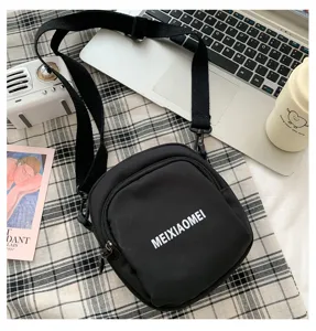 Black canvas crossbody bag for women, casual single shoulder bag with zipper pocket and strap.