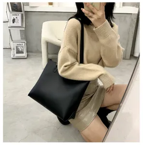 Minimalist black leather tote bag, large capacity stylish shoulder bag for women daily use.