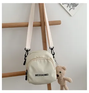 Korean style canvas crossbody bag with cute bear pendant, casual small shoulder bag for daily use.