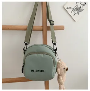 Green canvas crossbody bag for women, cute small shoulder bag with cute bear pendant.