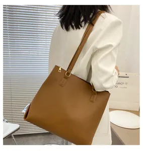 Brown leather large capacity shoulder tote bag detail view, minimalist casual daily design.