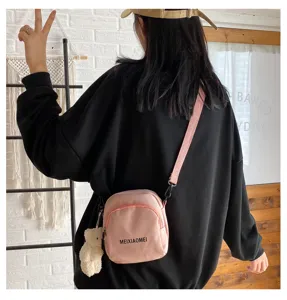 Pink canvas crossbody bag detail shot, sweet style cute small shoulder bag for teen girls.