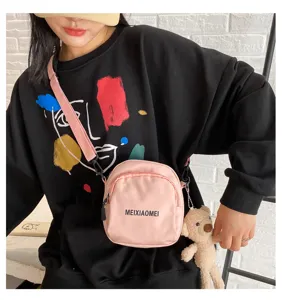 Cute pink canvas crossbody bag for women, stylish student shoulder bag with cute bear pendant.