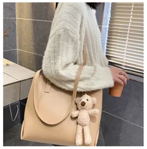 Stylish large capacity women tote shoulder bag with cute bear pendant for daily autumn wear.