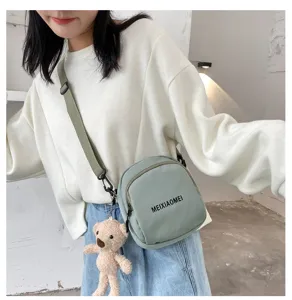 Trendy canvas crossbody bag for women, cute small shoulder bag with cute bear pendant.
