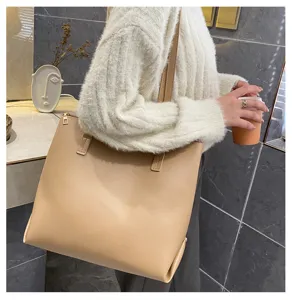 Classic minimalist beige tote bag detail showing large capacity, soft PU leather and strap.