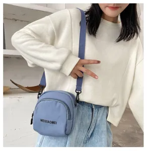 Casual canvas crossbody bag for women, trendy Korean style student shoulder bag with front pocket.