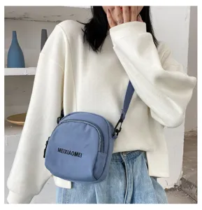 Small blue canvas crossbody bag for women, stylish casual shoulder bag with zipper closure.