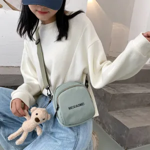 Canvas crossbody bag for women, cute small shoulder bag with bear pendant and adjustable strap.