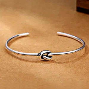 Silver plated open cuff bracelet with geometric knot design, retro style men's jewelry.