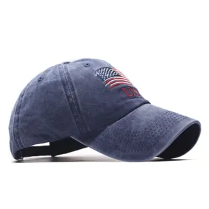 Close-up detail of the washed denim blue baseball cap featuring embroidered USA flag.