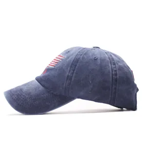 Detailed view of the distressed blue cotton baseball cap with embroidered patriotic flag motif.