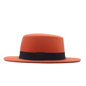 Detailansicht orangefarbener Wollfilz-Flachhut, schwarzes Band, Retro-Jazzhut Winter.