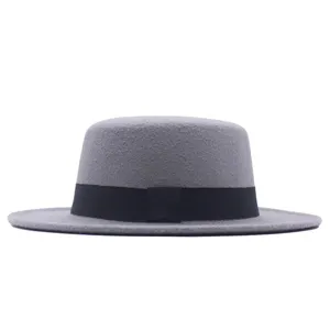 Detailansicht grauer Wollfilz Flachhut mit schwarzem Band, elegante Vintage Wintermode Accessoire.