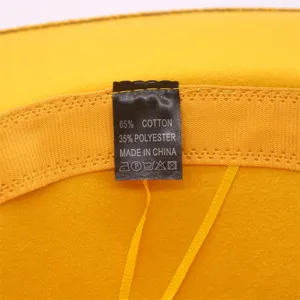 Detailansicht des Waschetiketts an einem gelben Wollfilzhut zur Materialzusammensetzung.