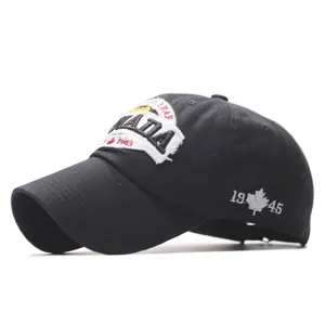Black cotton baseball cap with embroidered patch and side maple leaf detail for casual outdoor.