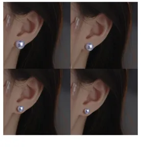 Gros plan détaillé d'élégantes boucles d'oreilles perles lilas portées à l'oreille.